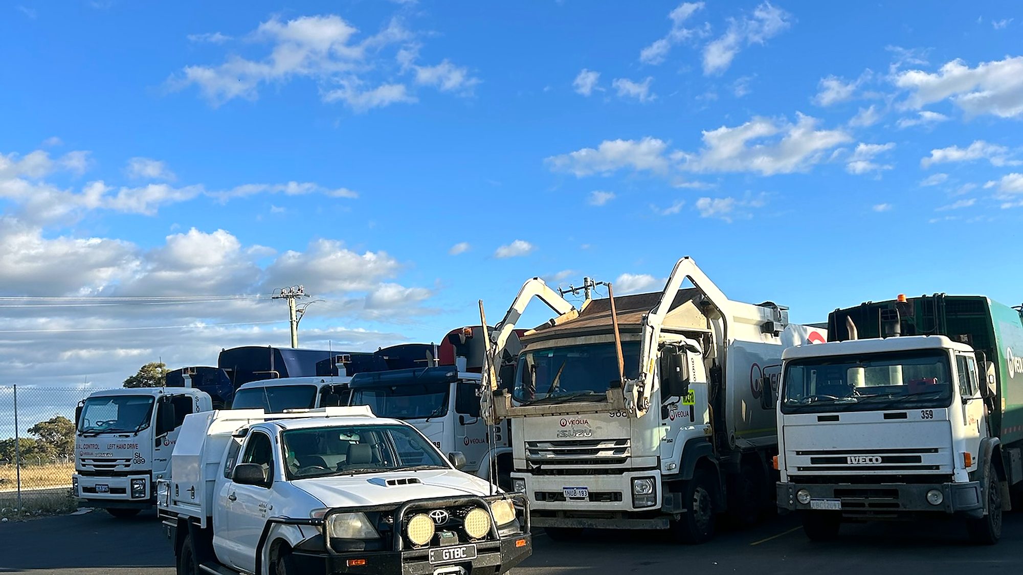 Heavy trucks and a service ute lined up in a South West depot yard serviced by Naturaliste Diesel Services