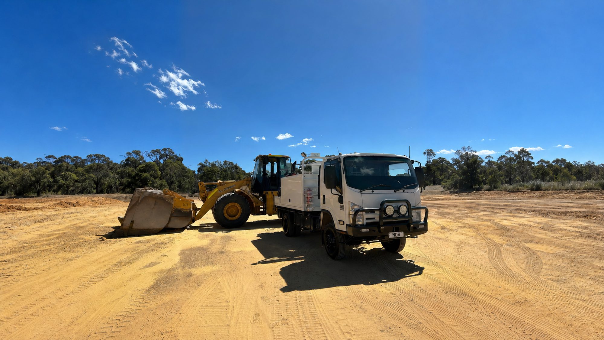 Naturaliste Diesel Services field-service truck and wheel loader on a South West job site