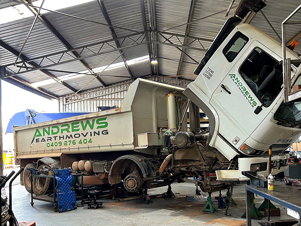Heavy tipper truck raised on stands for a compliance inspection in the Naturaliste Diesel Services workshop
